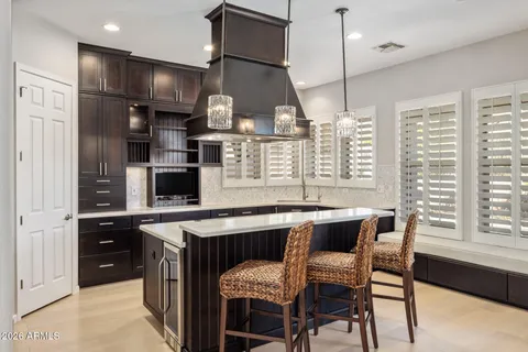 a kitchen with stainless steel appliances granite countertop a sink a stove and a refrigerator