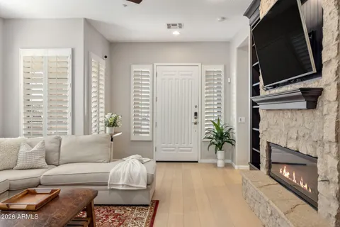 a living room with furniture a flat screen tv and a fireplace