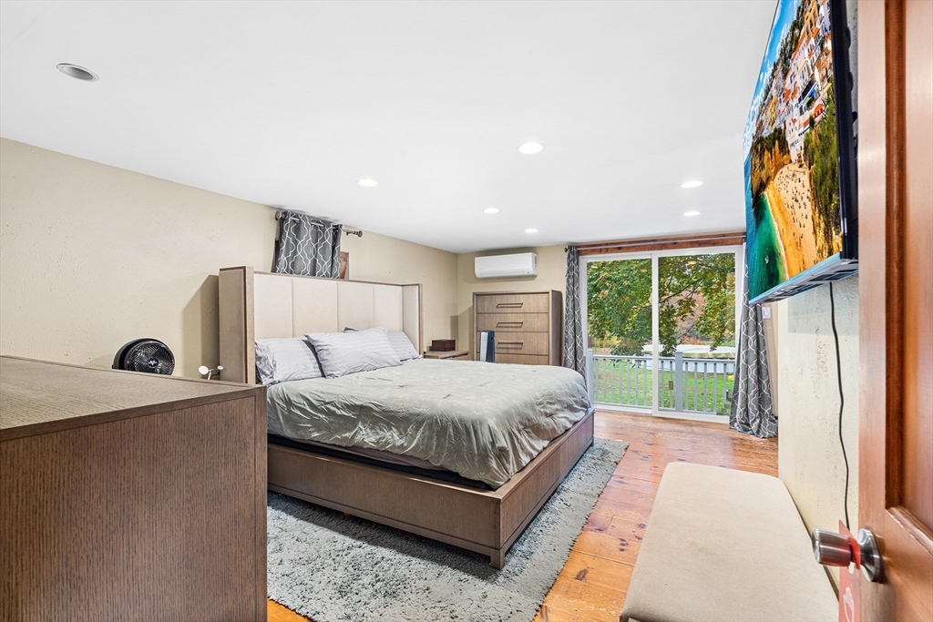 1052 Providence Road Northbridge, MA 01588 - Photo 19 of 42 a bedroom with a bed lamp and a large window