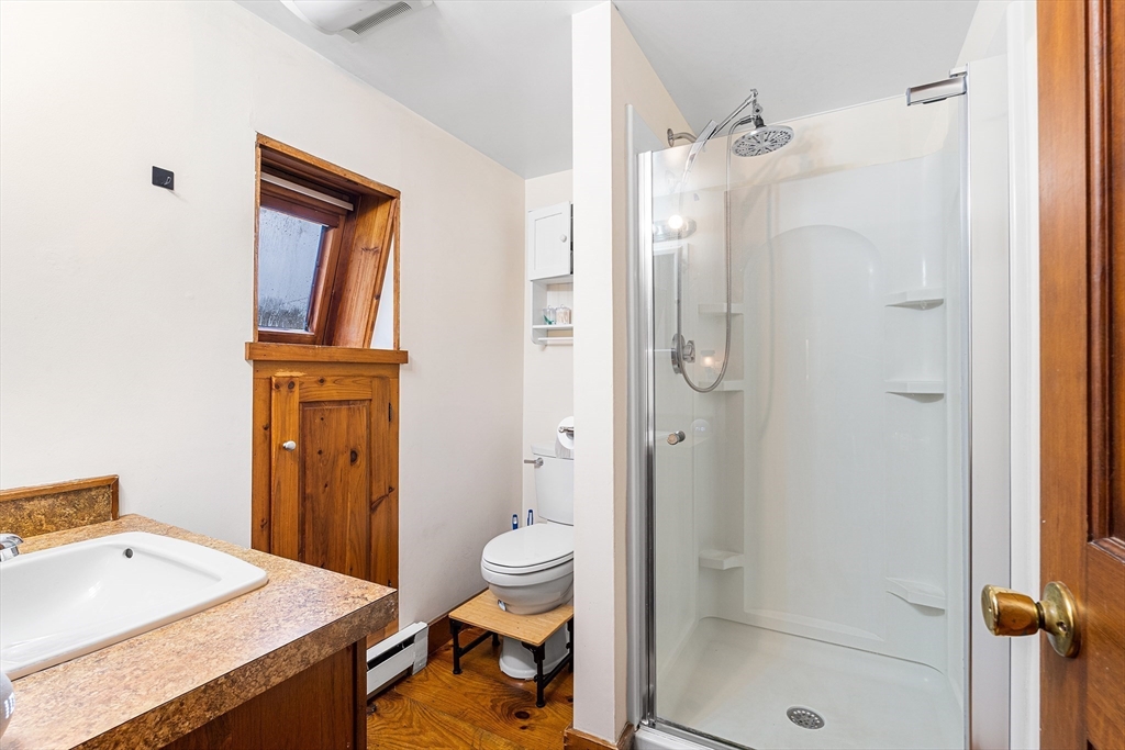1052 Providence Road Northbridge, MA 01588 - Photo 24 of 42 a bathroom with a granite countertop sink a toilet and shower