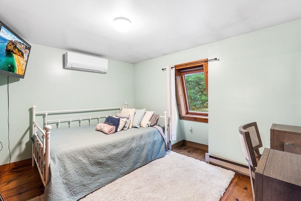 1052 Providence Road Northbridge, MA 01588 - Photo 25 of 42 a bedroom with a bed and wooden floor
