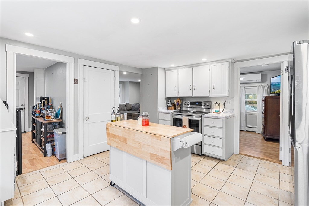 1052 Providence Road Northbridge, MA 01588 - Photo 10 of 42 a kitchen with white cabinets and appliances