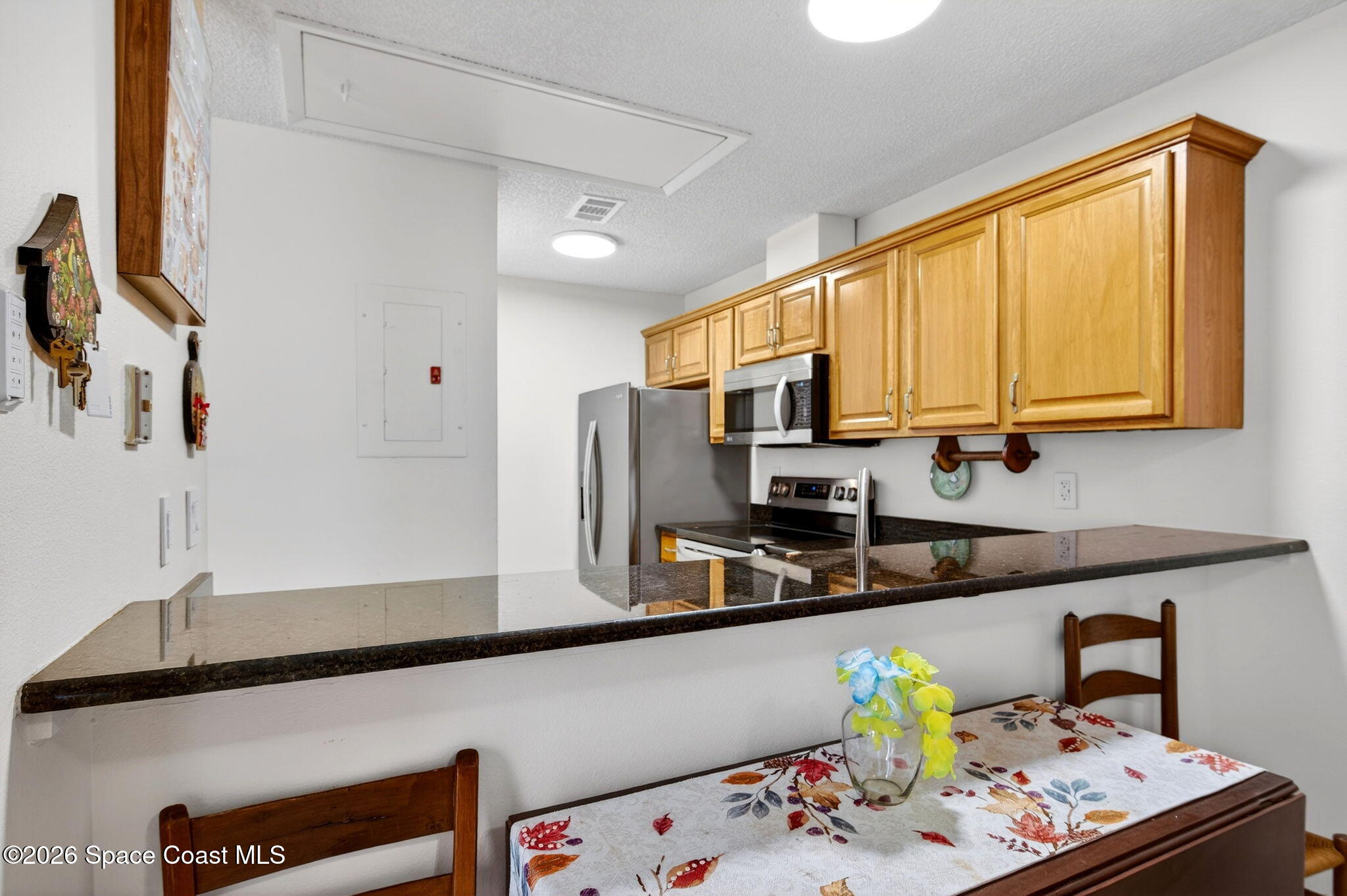 1400 Sheafe Avenue Northeast, Unit 110 Palm Bay, FL 32905 - Photo 12 of 35 a kitchen with stainless steel appliances a sink a stove a microwave a refrigerator and cabinets