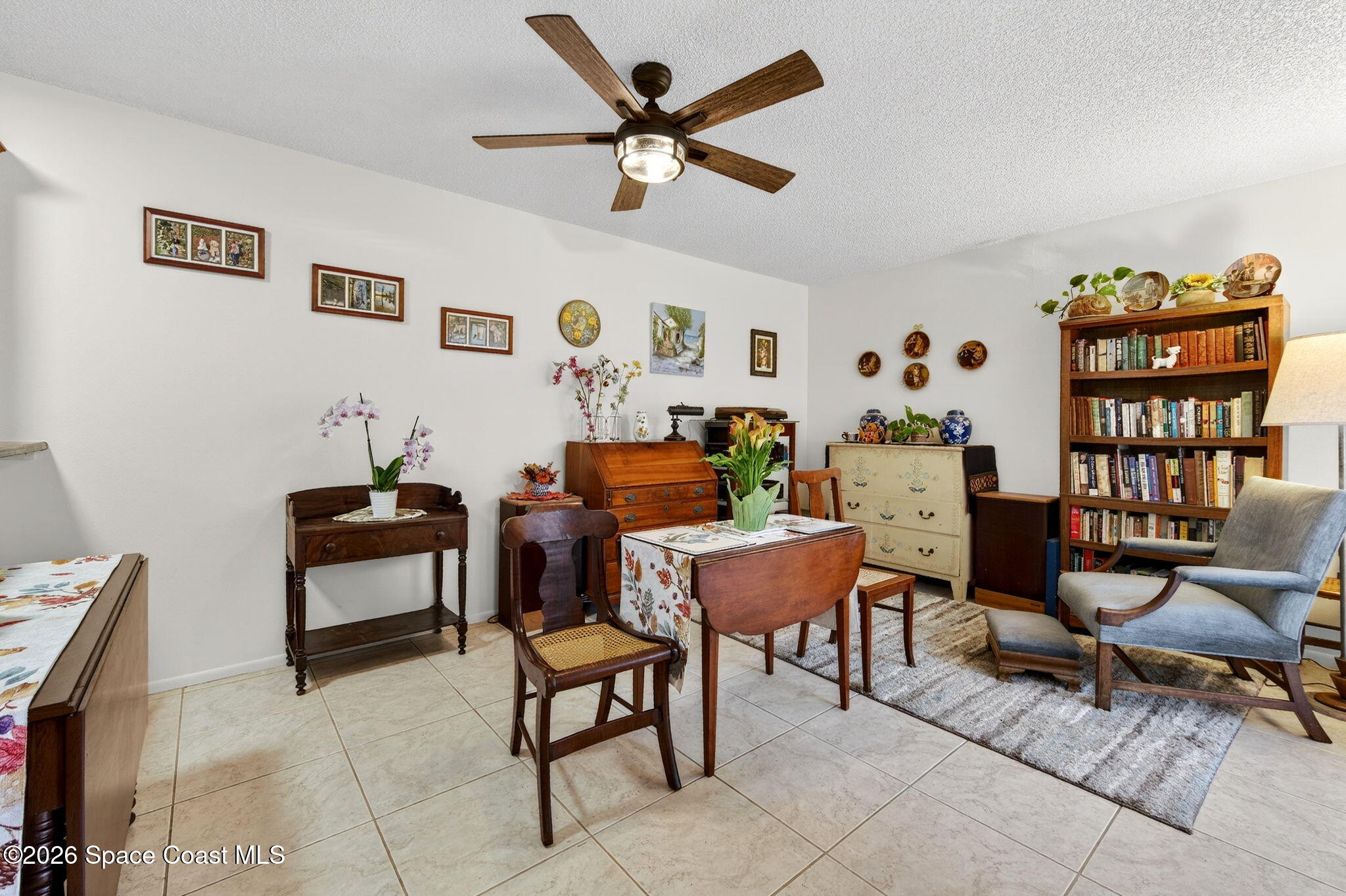1400 Sheafe Avenue Northeast, Unit 110 Palm Bay, FL 32905 - Photo 14 of 35 a work room with furniture and book shelf