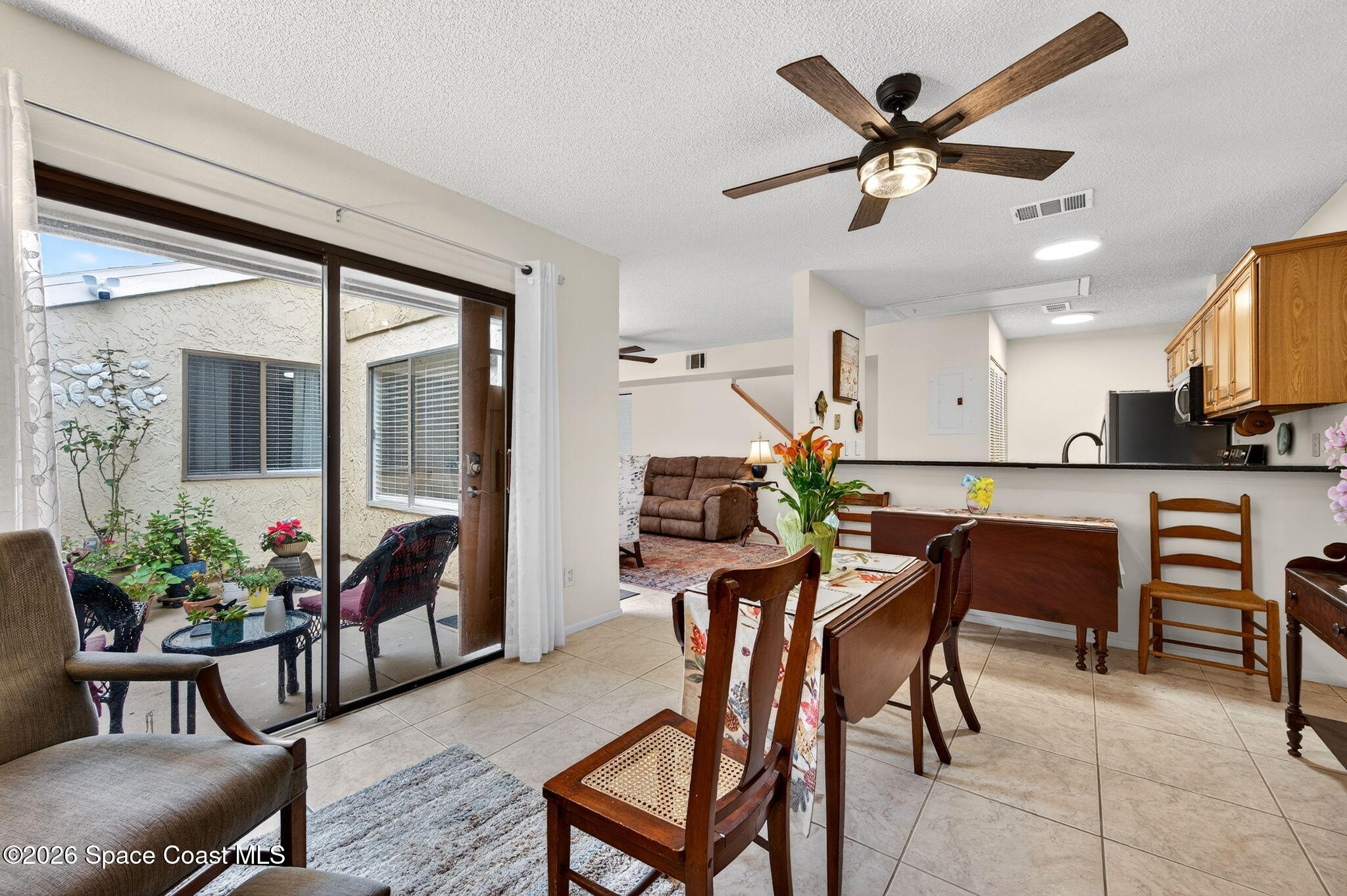 1400 Sheafe Avenue Northeast, Unit 110 Palm Bay, FL 32905 - Photo 17 of 35 a view of a livingroom with furniture and a potted plant
