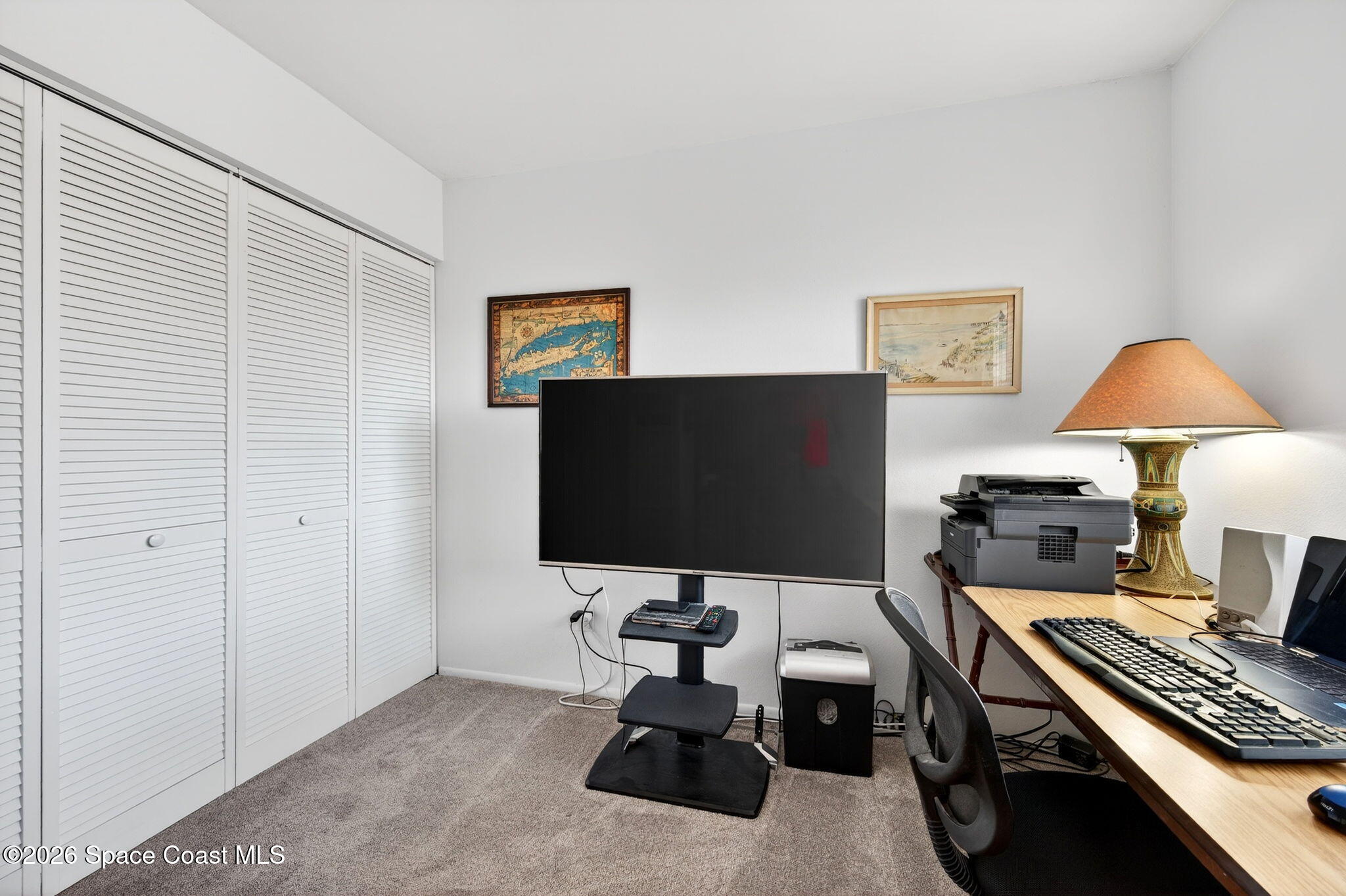 1400 Sheafe Avenue Northeast, Unit 110 Palm Bay, FL 32905 - Photo 27 of 35 a living room with furniture and a flat screen tv