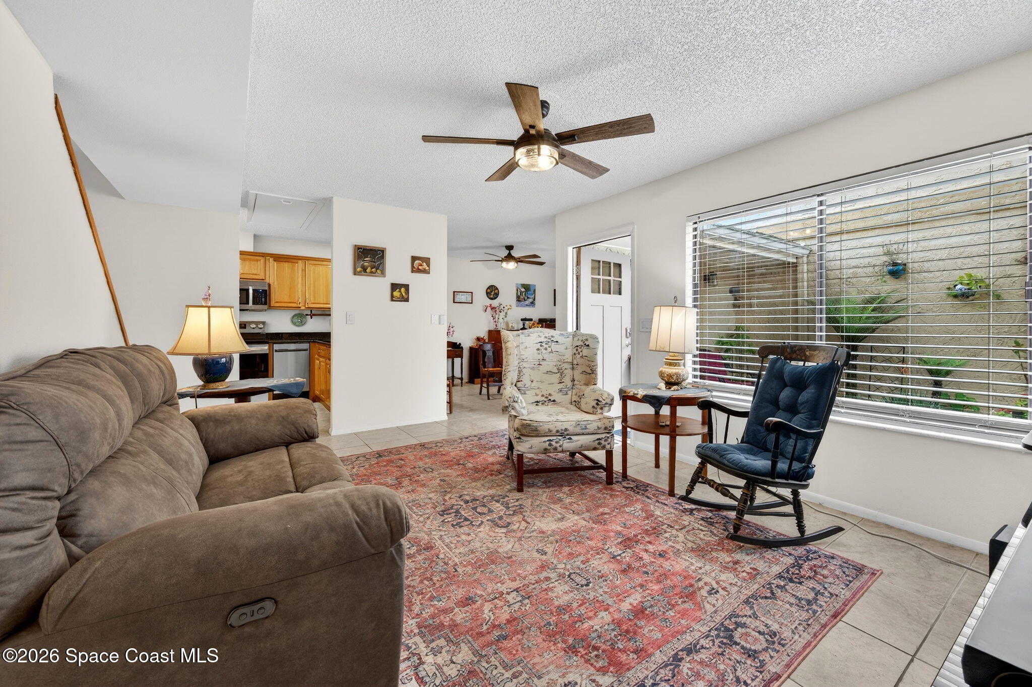 1400 Sheafe Avenue Northeast, Unit 110 Palm Bay, FL 32905 - Photo 6 of 35 a living room with furniture and a window