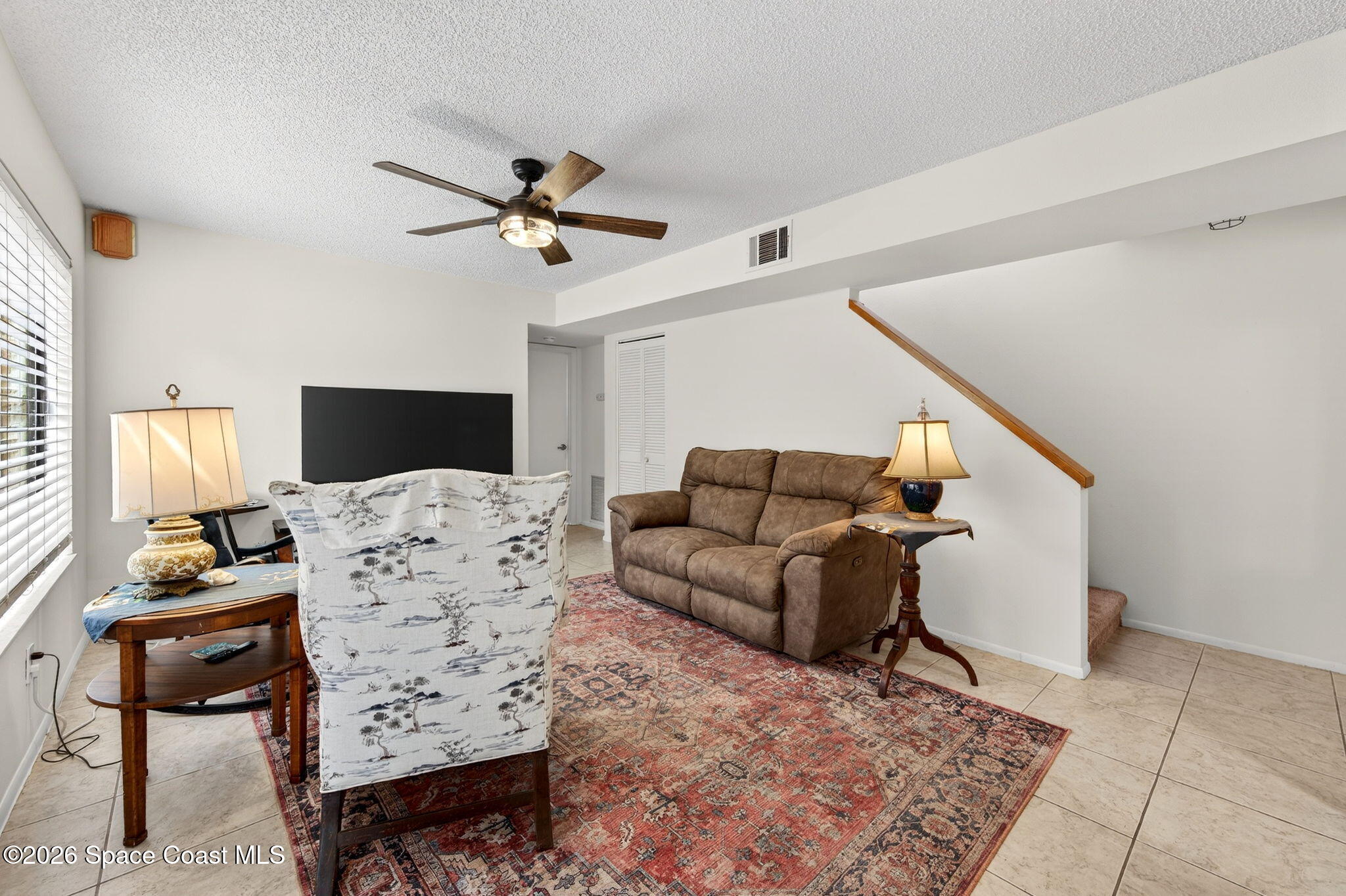 1400 Sheafe Avenue Northeast, Unit 110 Palm Bay, FL 32905 - Photo 7 of 35 a living room with furniture fireplace and a flat screen tv