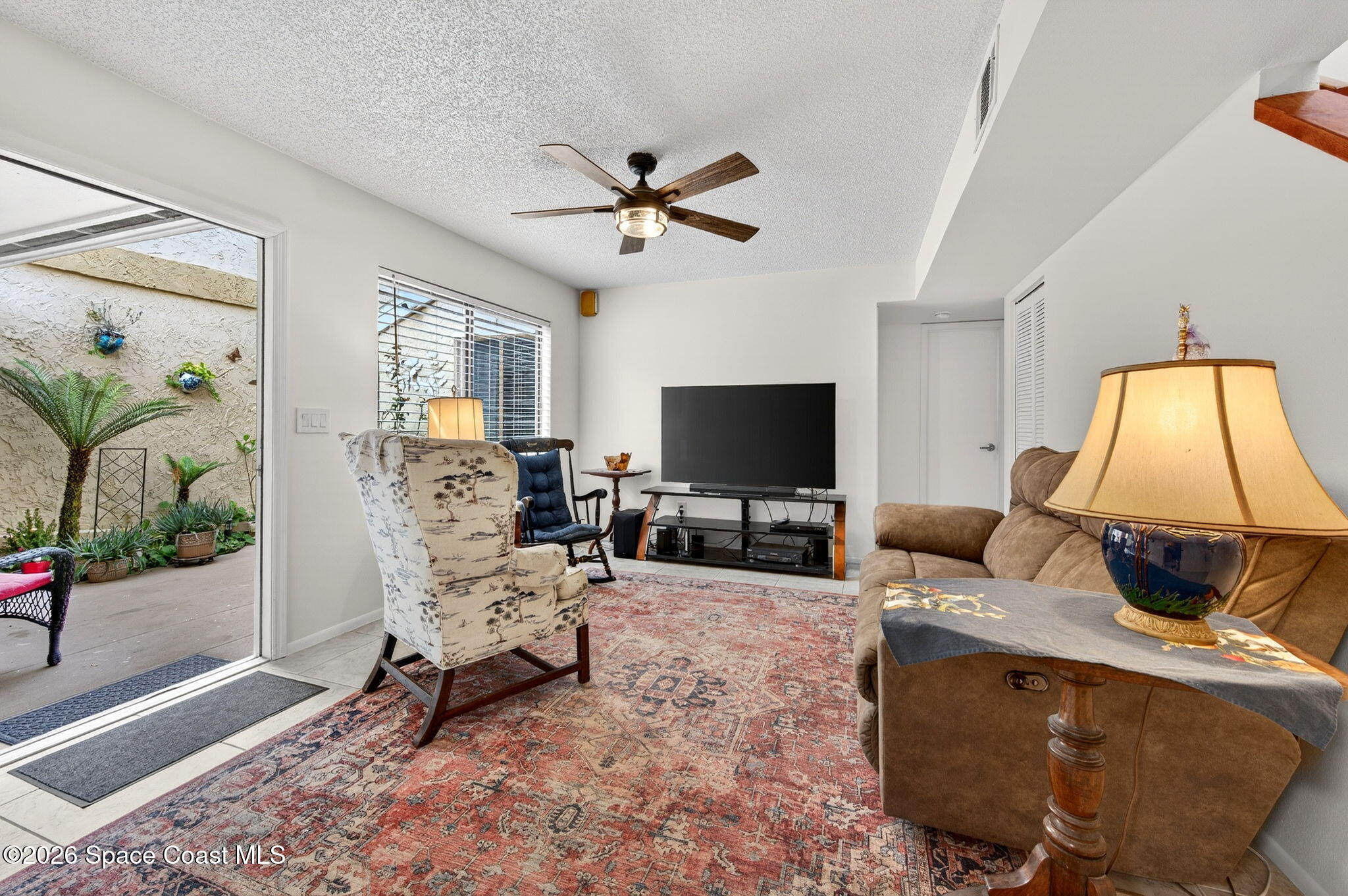 1400 Sheafe Avenue Northeast, Unit 110 Palm Bay, FL 32905 - Photo 9 of 35 a living room with furniture and a flat screen tv
