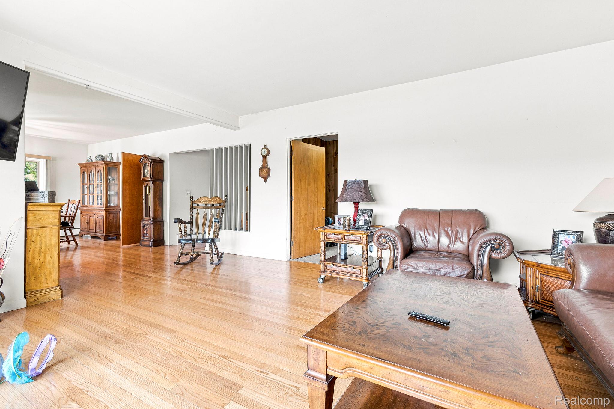 9735 Dolan Road Columbus, MI 48063 - Photo 22 of 63 Bright interior space featuring wood-finish flooring, white walls, and an open layout