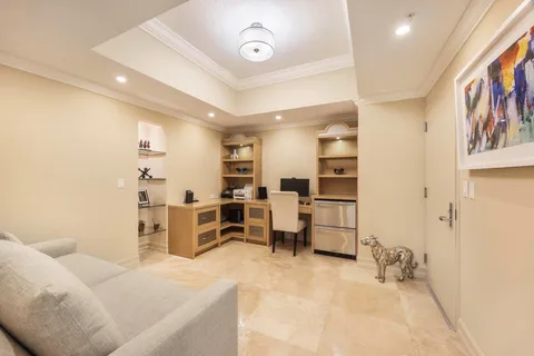 a large bedroom with a bed and furniture
