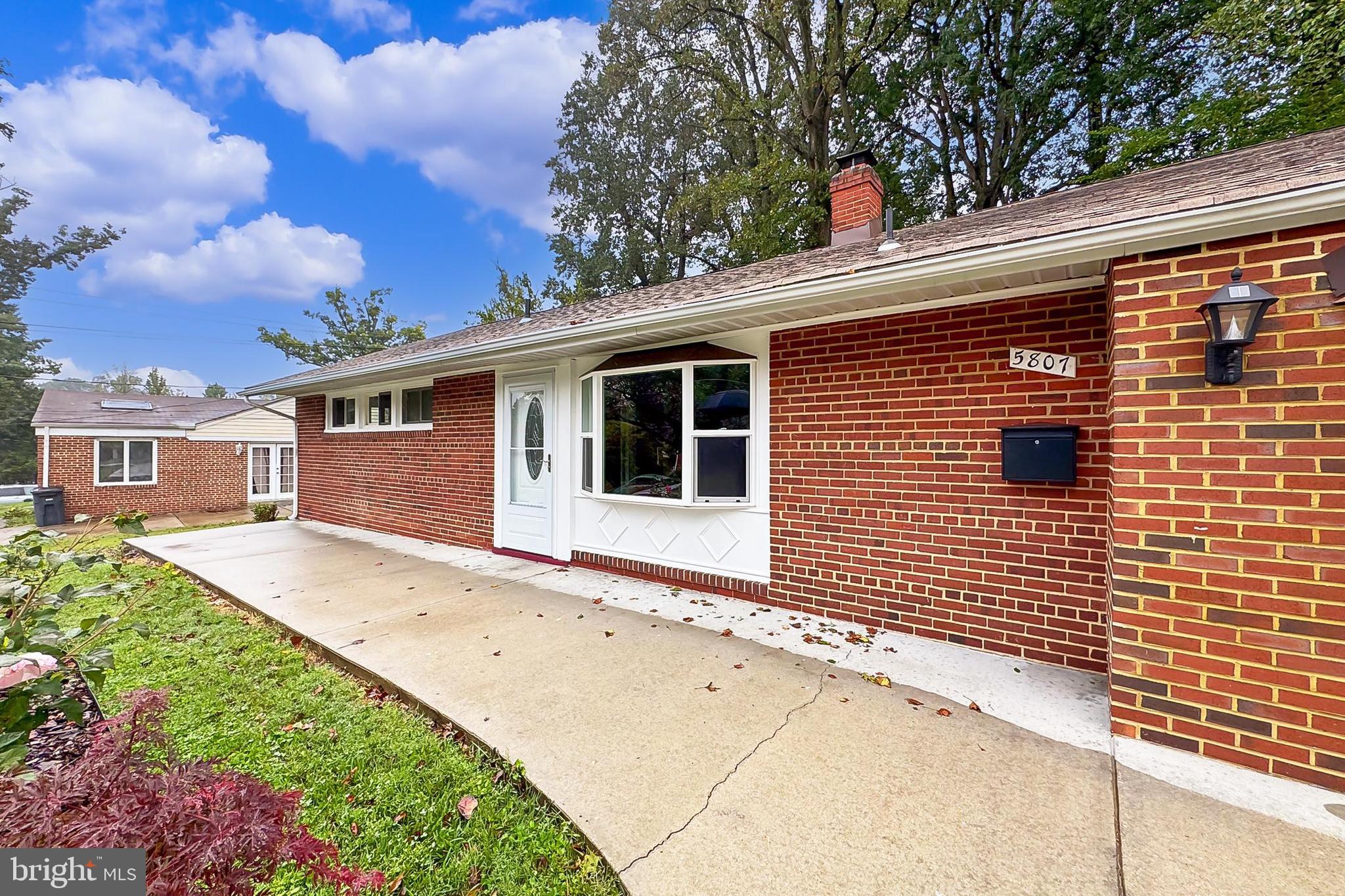 5807 Accomac Street Springfield, VA 22150 - Photo 17 of 50 a front view of a house with a garden