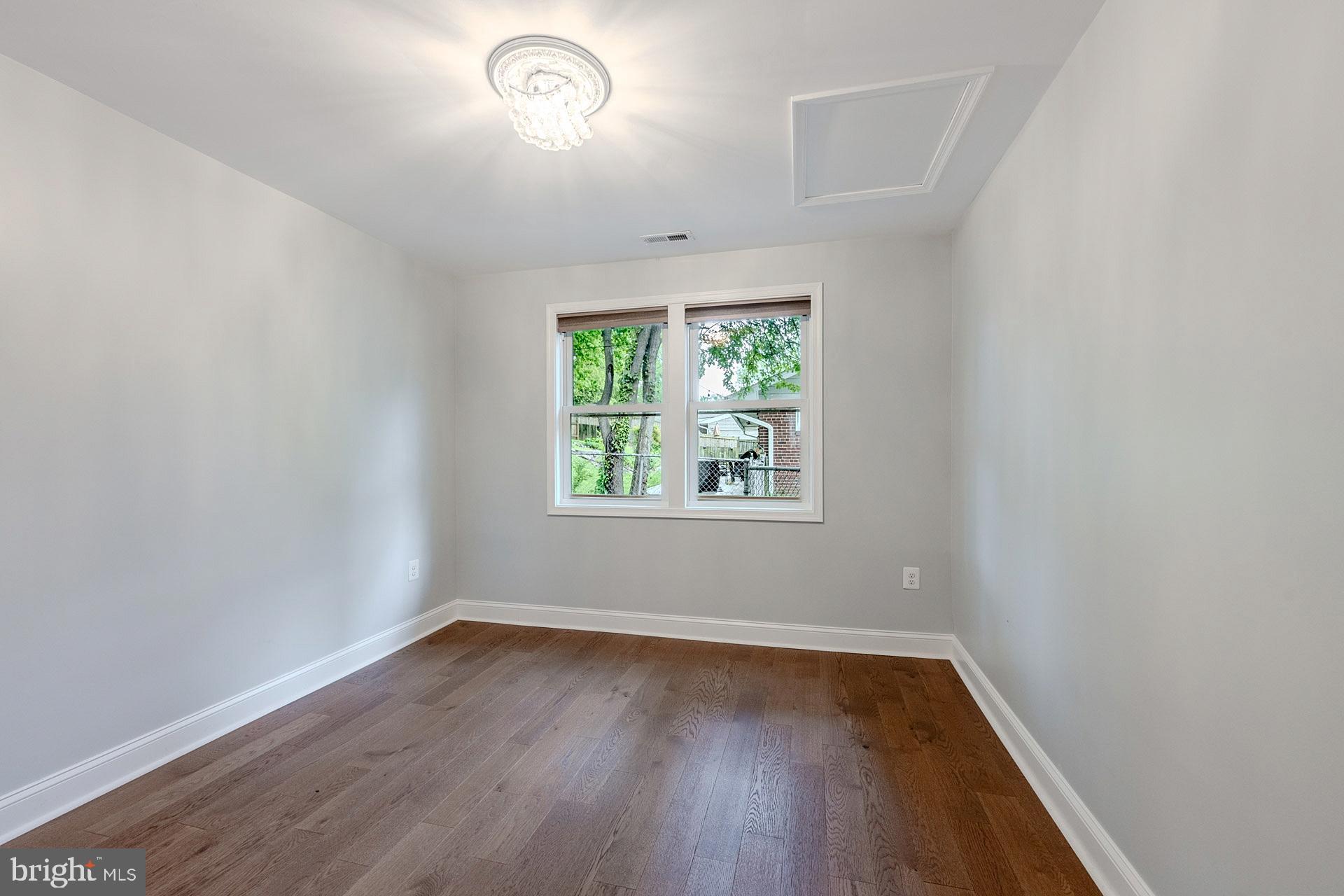 5807 Accomac Street Springfield, VA 22150 - Photo 29 of 50 an empty room with wooden floor and windows