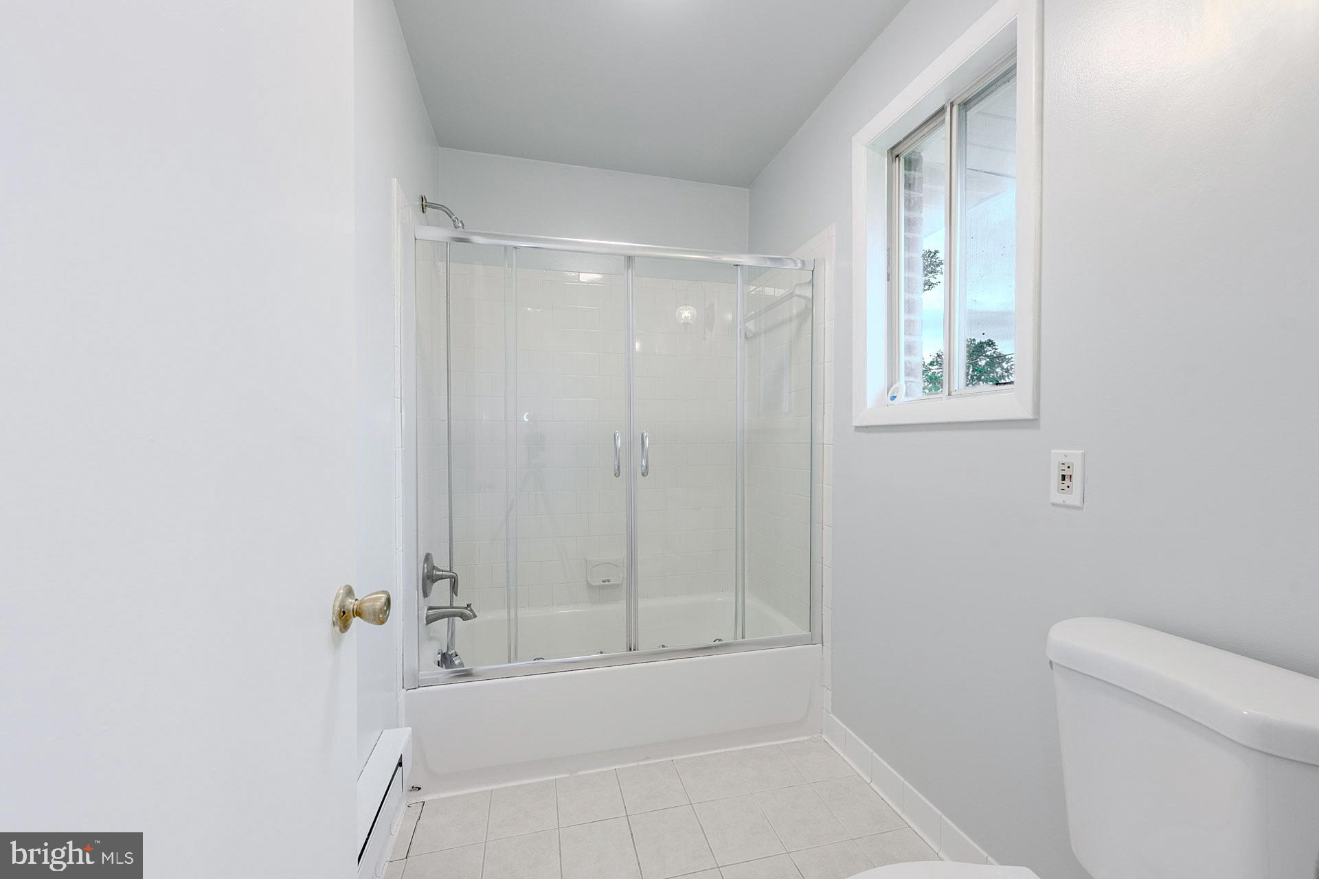 5807 Accomac Street Springfield, VA 22150 - Photo 35 of 50 a bathroom with a bathtub and a shower