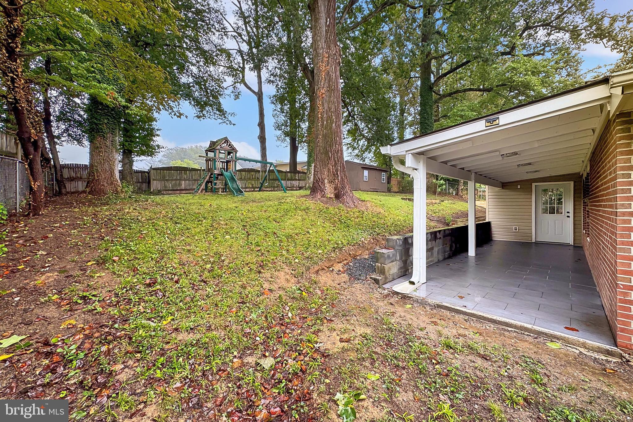 5807 Accomac Street Springfield, VA 22150 - Photo 43 of 50 a view of a house with backyard and trees