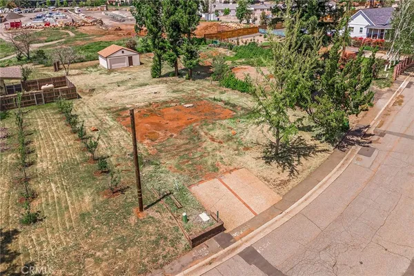 a view of swimming pool with a lawn chairs and plants
