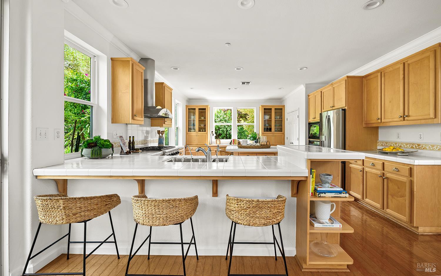 38 Maybeck Street Novato, CA 94949 - Photo 15 of 47 a kitchen with granite countertop white cabinets and chairs