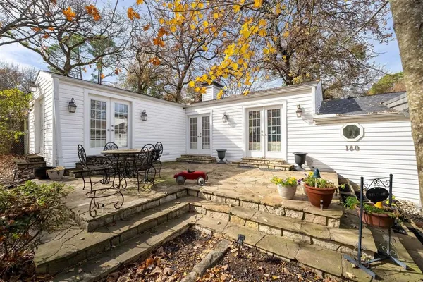 a house view with a sitting space and garden