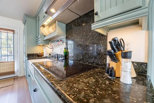 a kitchen with a sink and a stove top oven