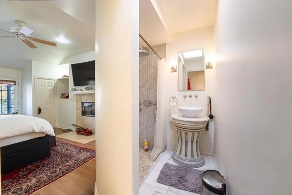a bathroom with a sink a mirror and a shower