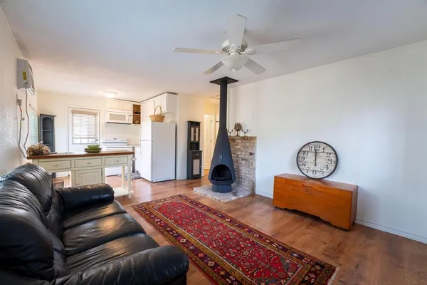 a living room with furniture and a view of kitchen
