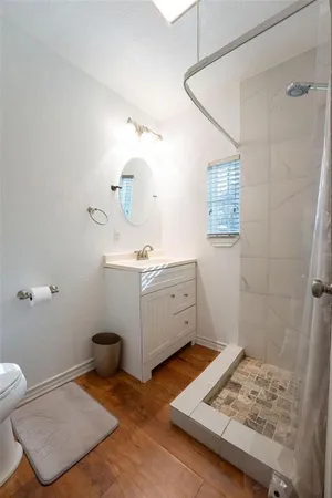 a bathroom with a sink toilet and shower