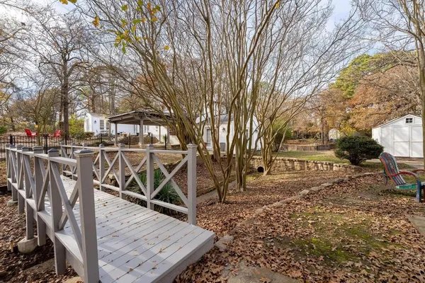 a view of a backyard with wooden fence