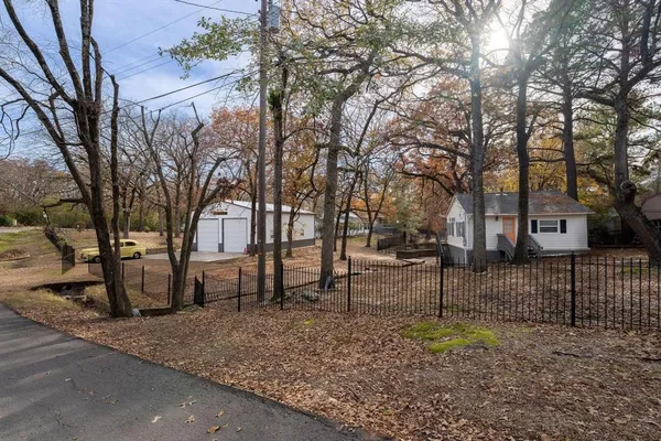 a backyard of a house with lots of trees