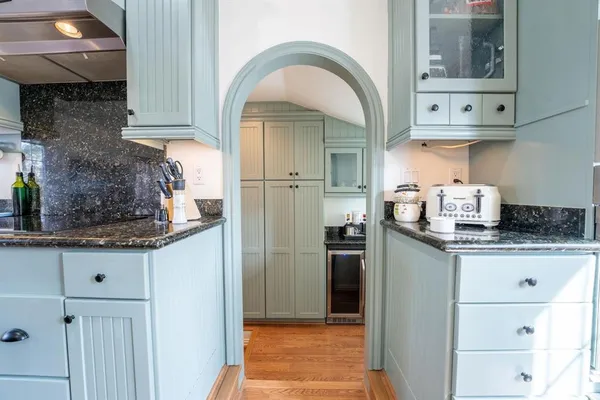 a kitchen with stainless steel appliances granite countertop a refrigerator and a stove