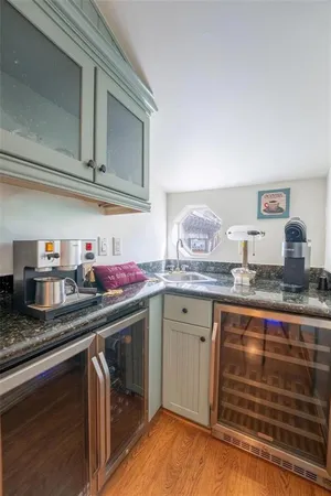 a kitchen with granite countertop a sink stove and cabinets