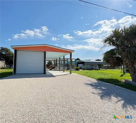 a view of a house with a yard and garage