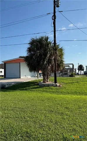 a swimming pool with outdoor seating and yard