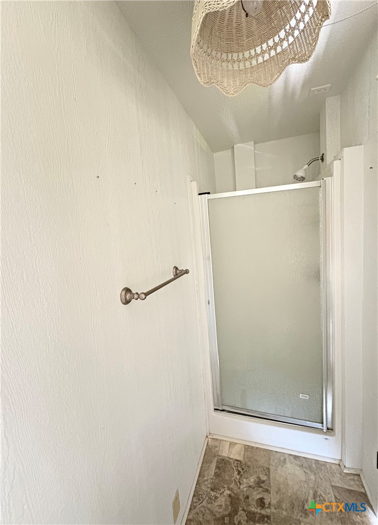 109 Washington Boulevard Port O'Connor, TX 77982 - Photo 4 of 23 a bathroom with a glass shower door