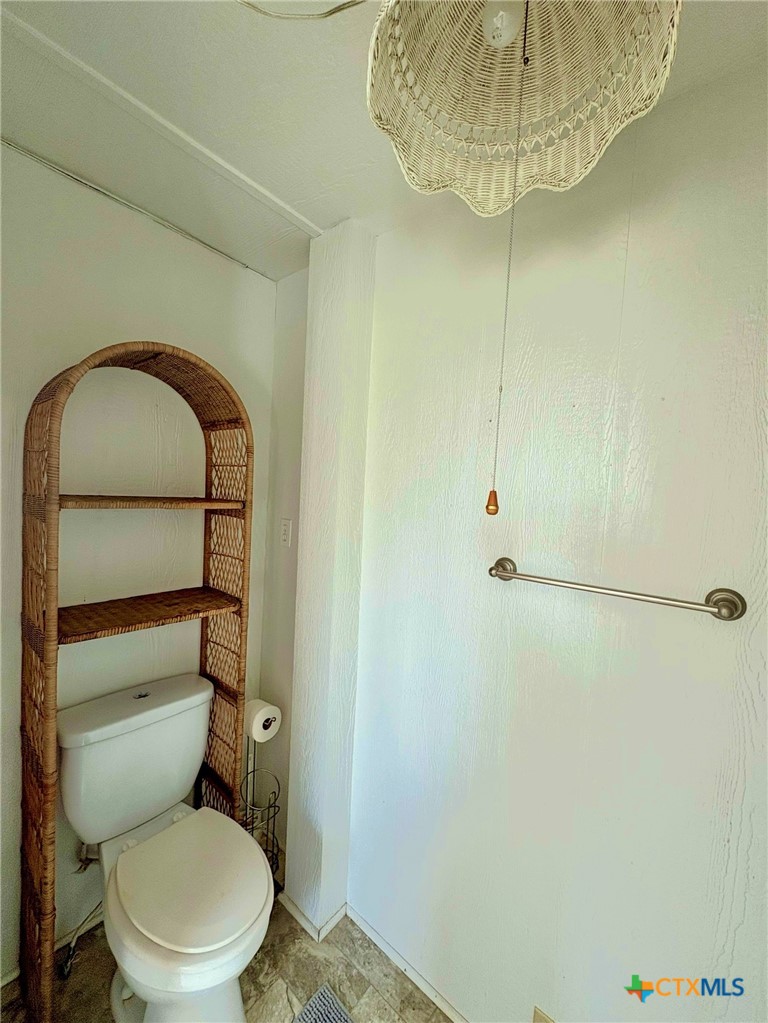 109 Washington Boulevard Port O'Connor, TX 77982 - Photo 5 of 23 a bathroom with a toilet and a sink