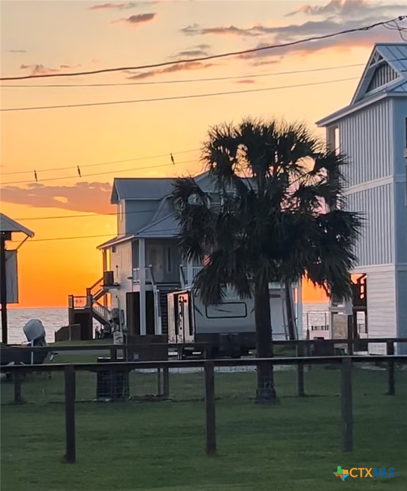 109 Washington Boulevard Port O'Connor, TX 77982 - Photo 6 of 23 a view of a lake with a big yard potted plants and large tree