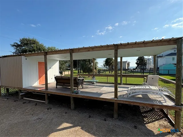 a view of a balcony with wooden floor