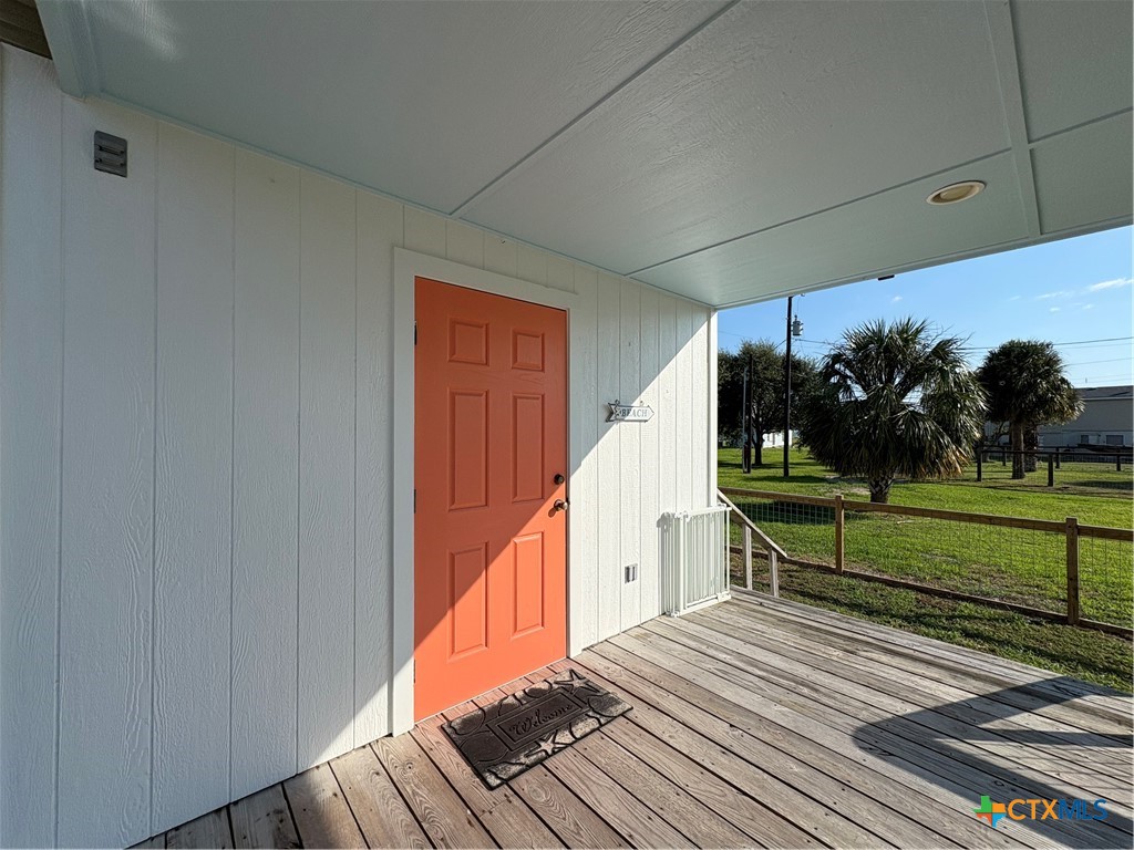 109 Washington Boulevard Port O'Connor, TX 77982 - Photo 9 of 23 a view of a house with wooden floor and trees in the background