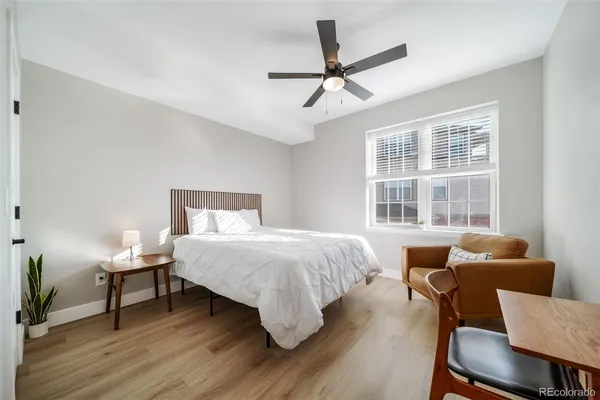 a bedroom with a bed and wooden floor