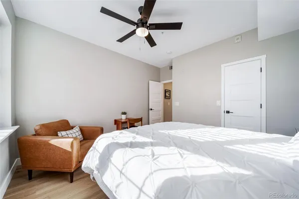 a bedroom with bed and a ceiling fan