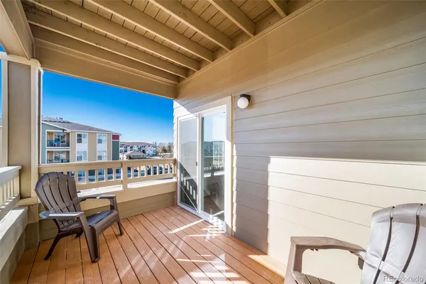a balcony with furniture and a rug