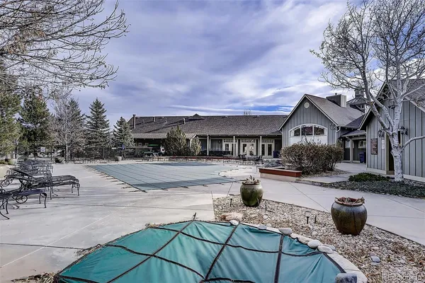 a view of house with swimming pool and sitting area