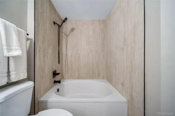 a bathroom with a bathtub and shower