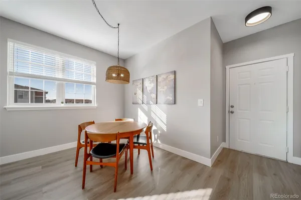 a view of a dining room with furniture and wooden floor