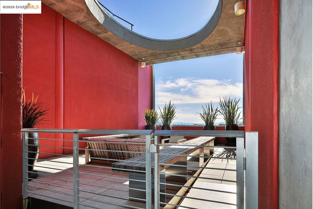 311 Oak Street, Unit 816 Oakland, CA 94607 - Photo 20 of 20 a view of balcony with wooden floor and a potted plant