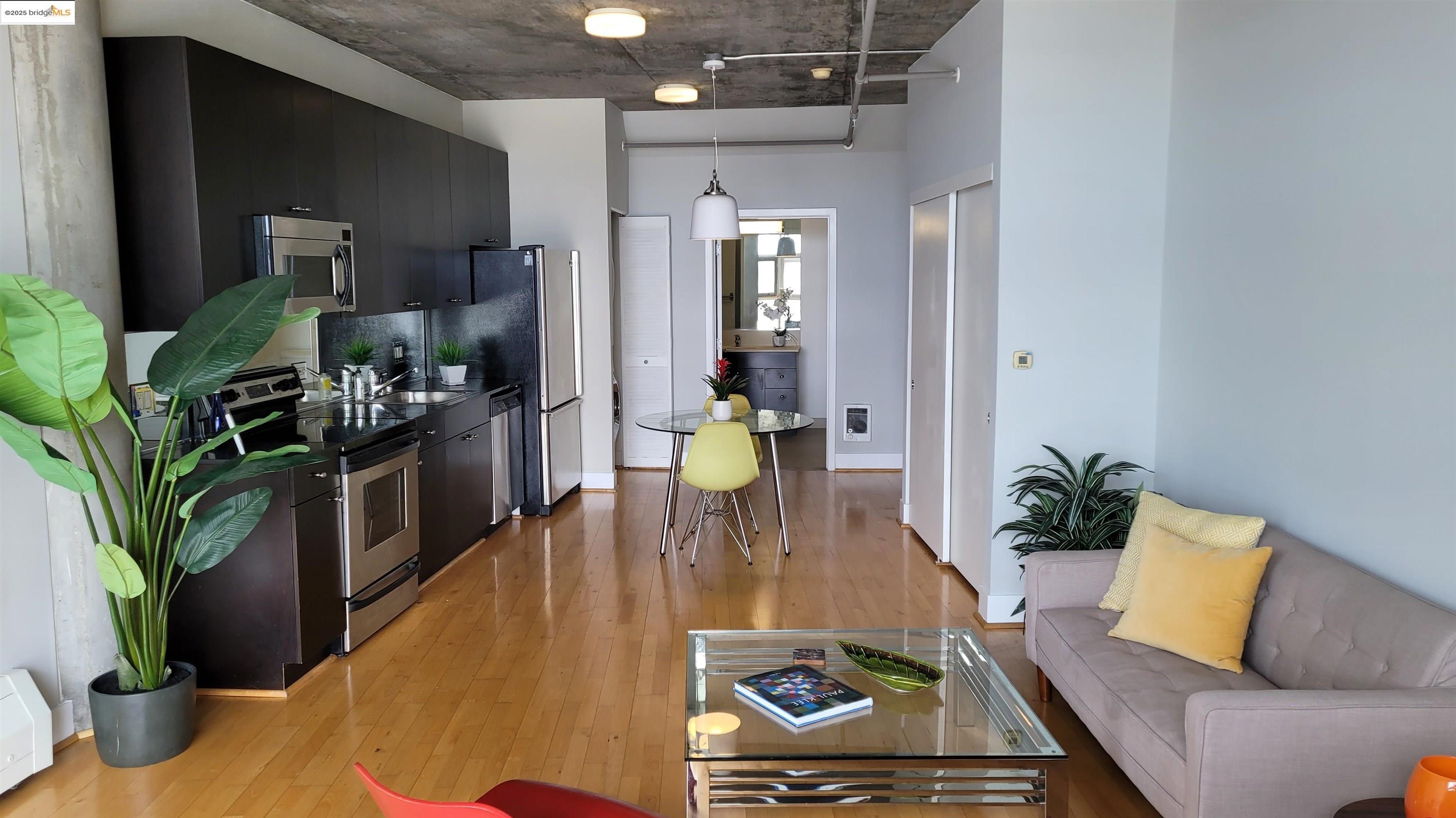311 Oak Street, Unit 816 Oakland, CA 94607 - Photo 7 of 20 a dining room with furniture and wooden floor