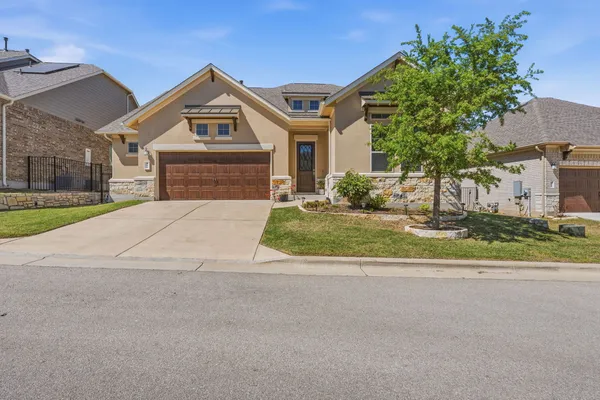 a front view of a house with a yard and garage