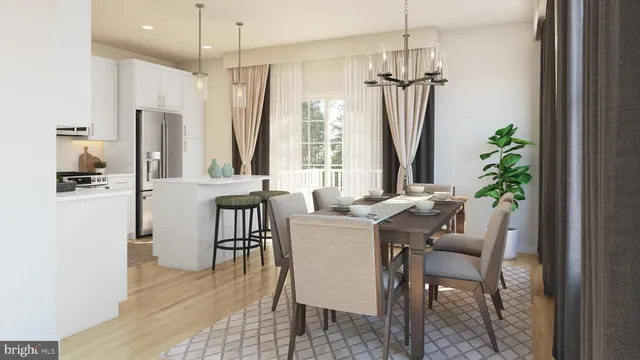 a dining room with furniture potted plants and wooden floor