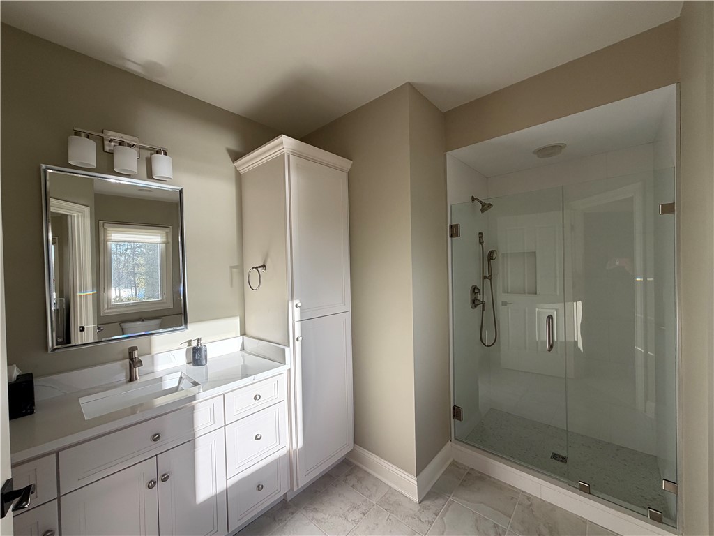357 Stardust Lane Seneca, SC 29672 - Photo 35 of 50 Bathroom 3-A glass-enclosed shower highlights this modern washroom featuring a white vanity setup.