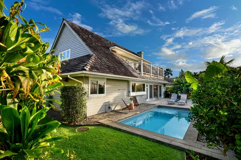 a front view of house with a garden