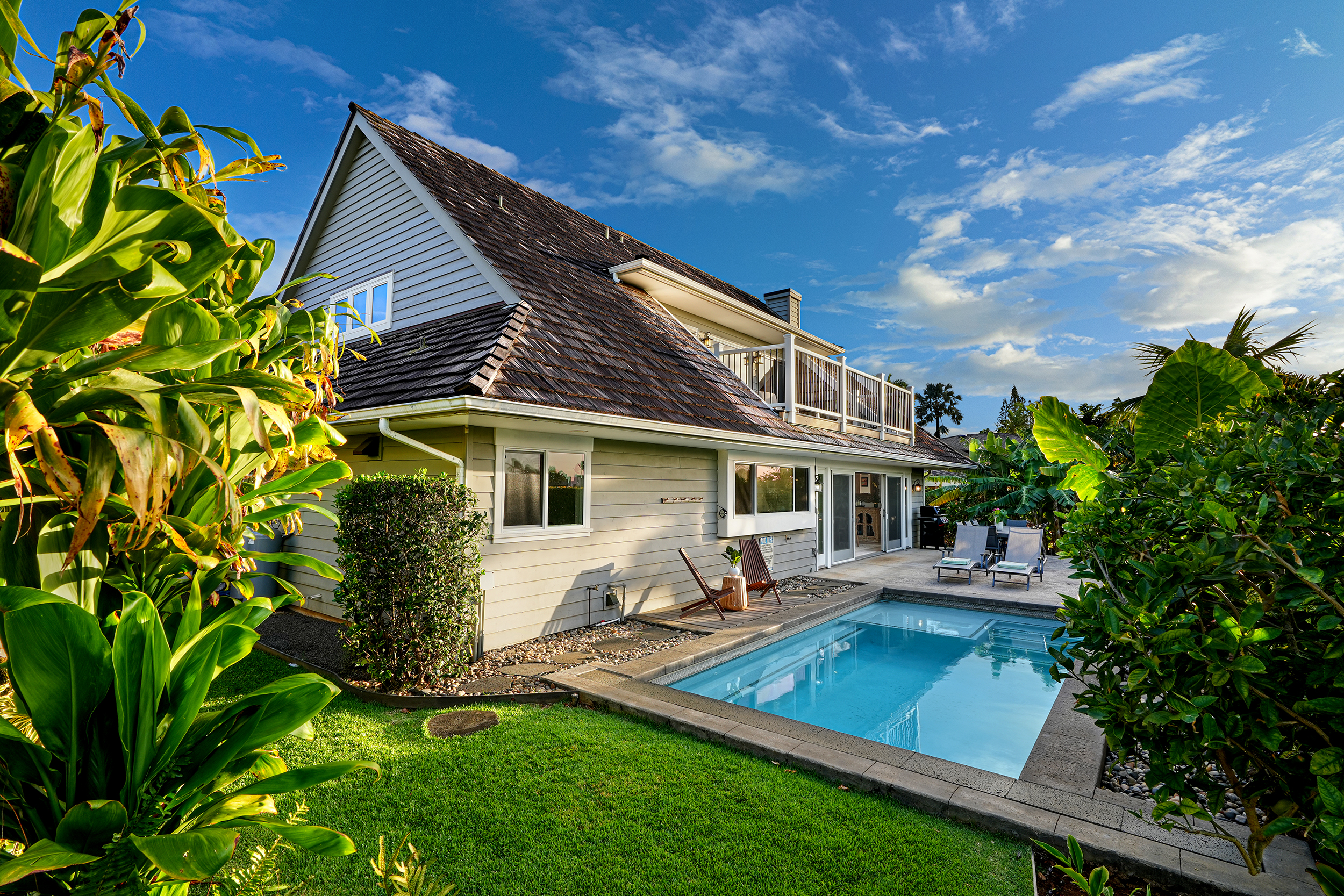 5348 Honoiki Road Princeville, HI 96722 - Photo 24 of 25 a front view of house with a garden